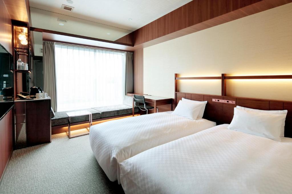Postel nebo postele na pokoji v ubytování Candeo Hotel Utsunomiya