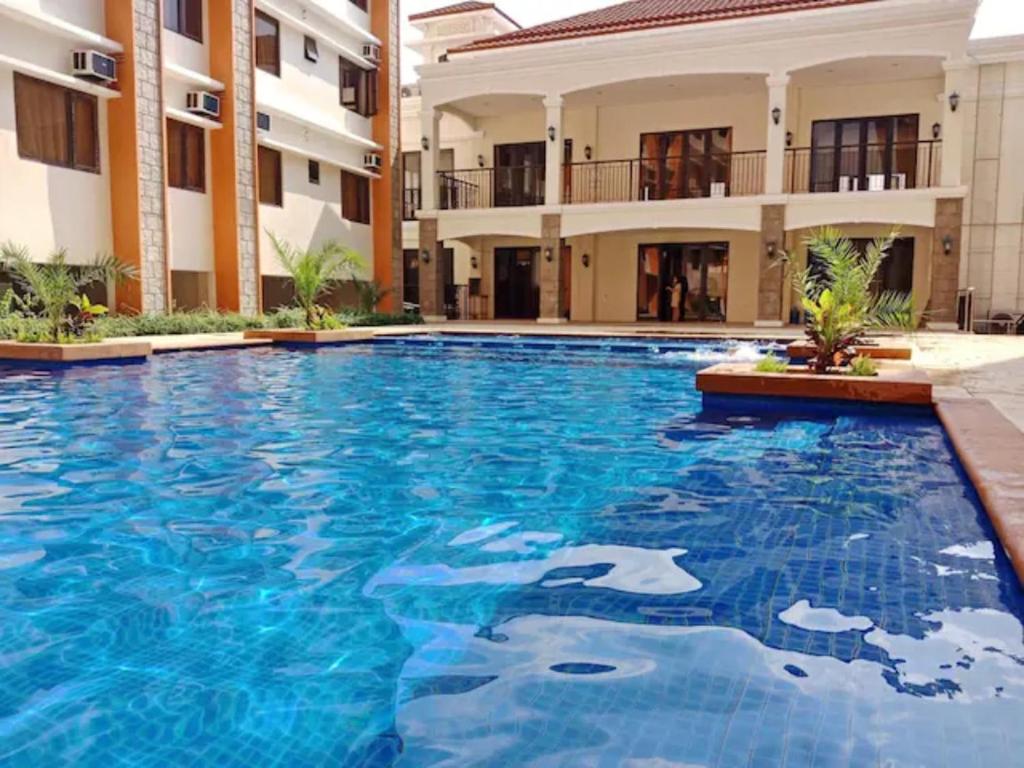 a large swimming pool in front of a building at Paseo Verde Condominium 1 Bedroom for 6 pax in Manila