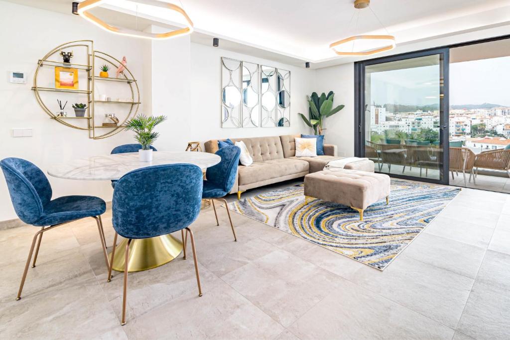 a living room with a couch and a table and chairs at INF25E- Tastefully furnished flat, Estepona center in Estepona