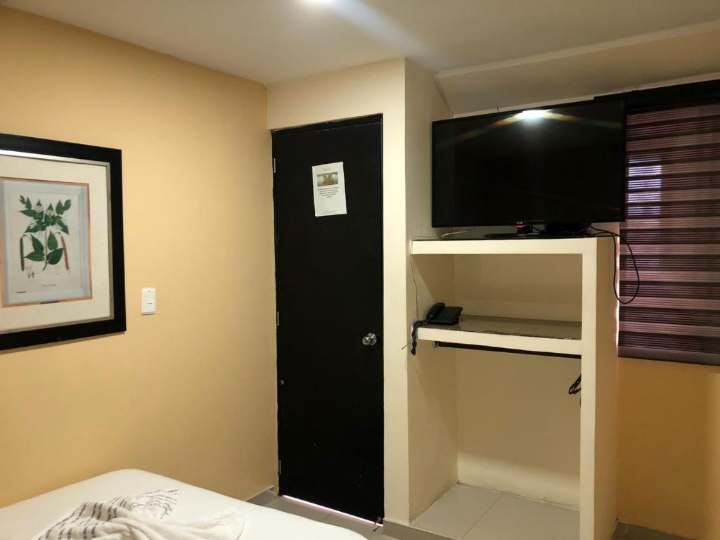 Postel nebo postele na pokoji v ubytování Hotel Ecosuite Quibdó