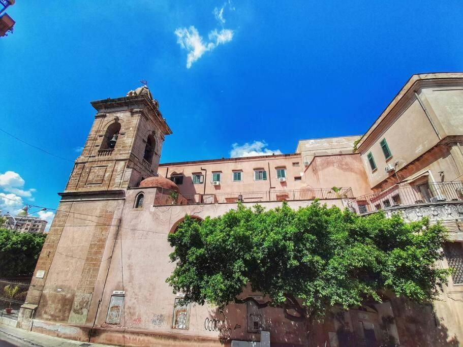 a building with a clock tower on top of it at Sant'Oliva28 in Palermo