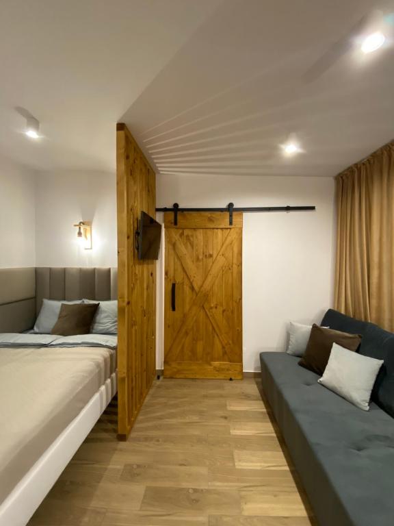 a bedroom with two beds and a wooden door at Apartament La Playa! Najlepsza lokalizacja! in Hel