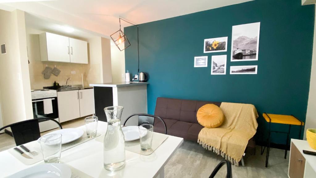 a living room with a table and a couch at Amanecer del Fuego III in Ushuaia