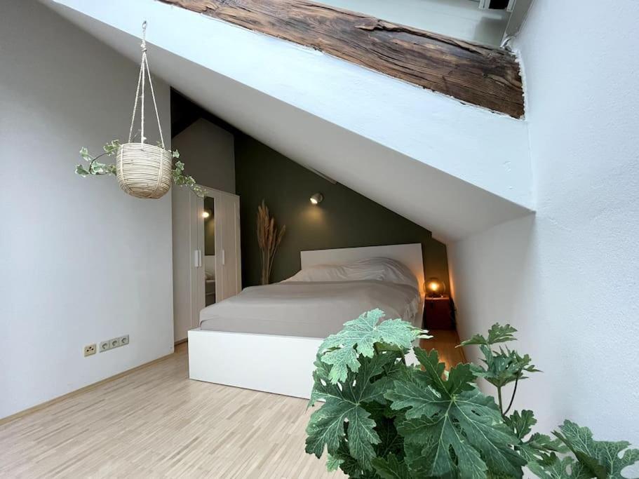 a bedroom with a bed in an attic at Helles Apartment im Zentrum in Graz