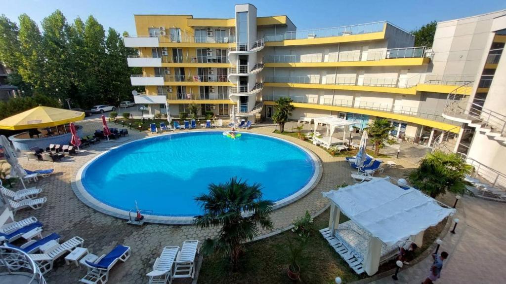 a large swimming pool in front of a building at Dima Popova Apartments in Tsarevo