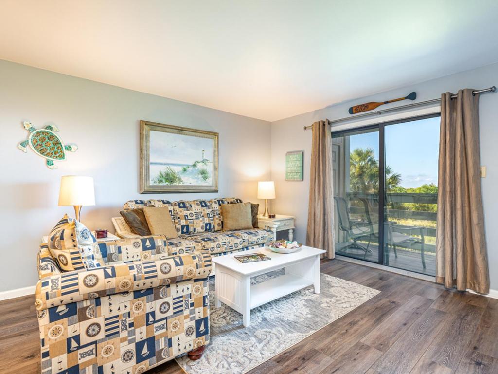 a living room with a couch and a table at Lighthouse Point 20A in Tybee Island