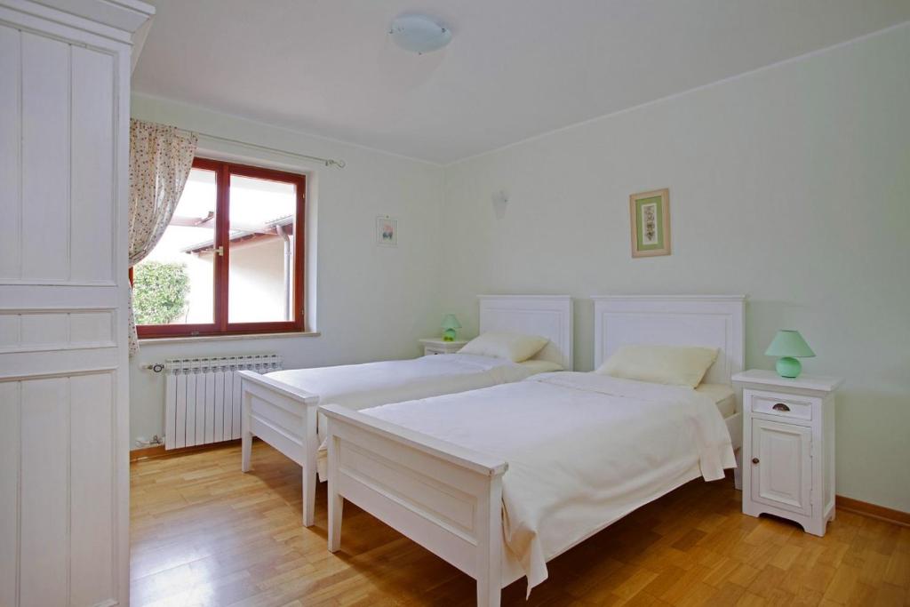 Postel nebo postele na pokoji v ubytování Villa Aurata in Ližnjan (Haus für 8-9 Personen)