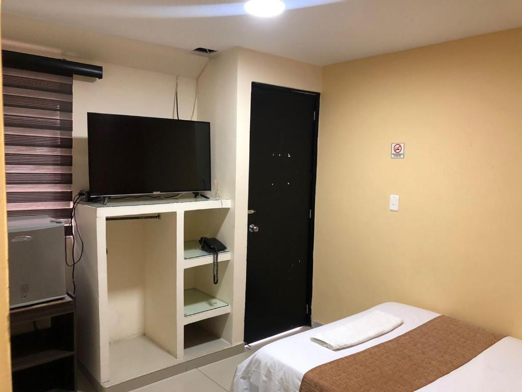 TV a/nebo společenská místnost v ubytování Hotel Ecosuite Quibdó