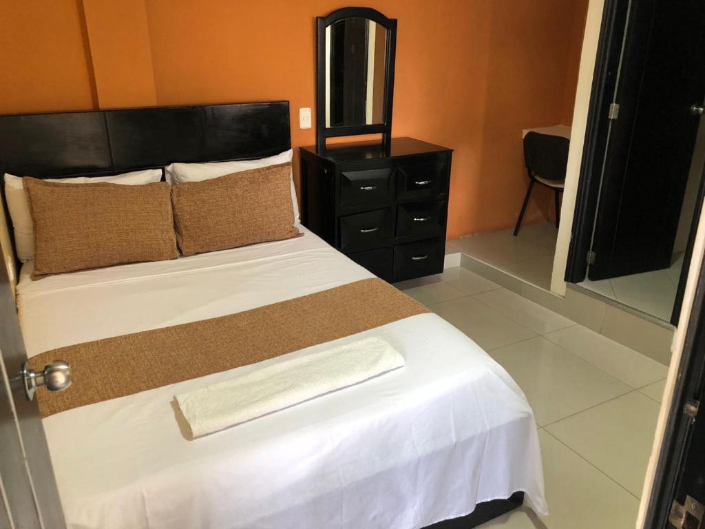 Postel nebo postele na pokoji v ubytování Hotel Ecosuite Quibdó