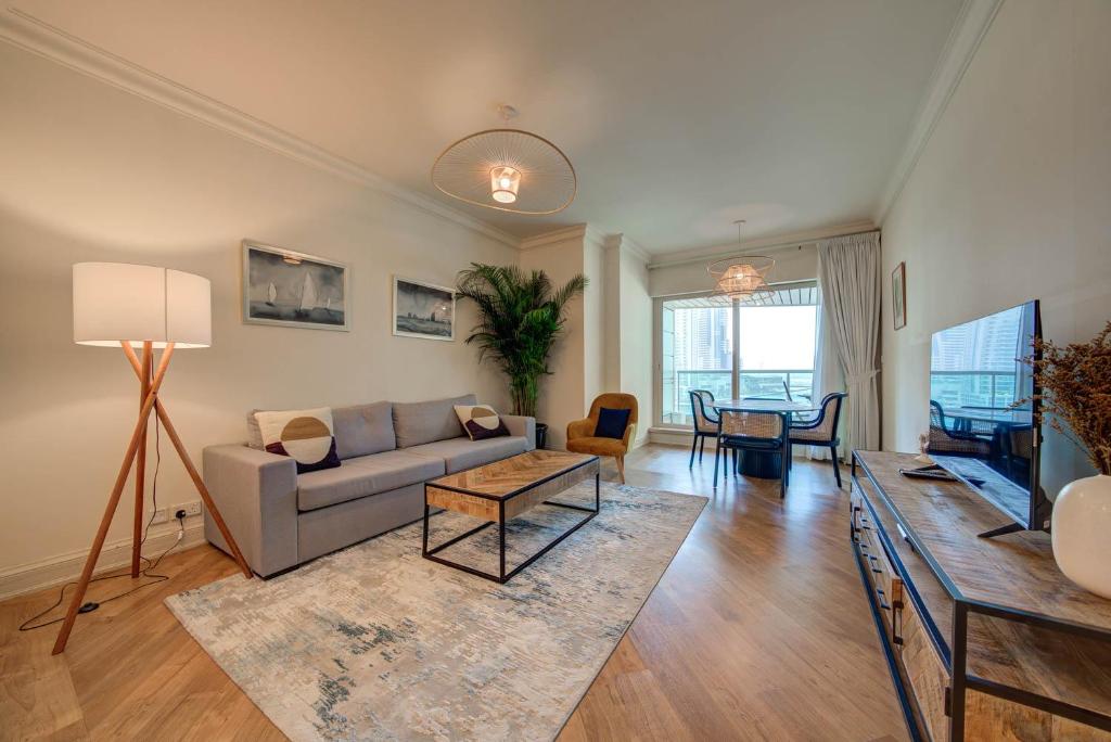 a living room with a couch and a table at Stunning 2BR l Marina View in Dubai