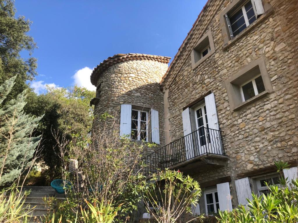 a large brick building with a chimney on it at Domaine La Tour - SPA - Jacuzzi - Sauna - Massage - 4 SAISONS - Piscine Chauffée Toute l'année - Heated POOL - 800m City Centre Nyons in Nyons