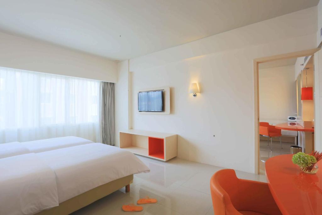 Postel nebo postele na pokoji v ubytování HARRIS Hotel & Conventions Ciumbuleuit Bandung