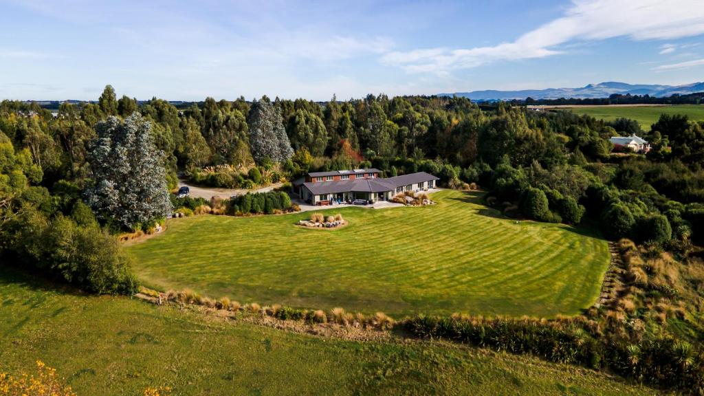 an aerial view of a large house on a green field at Hokonui Bed & Breakfast in Gore