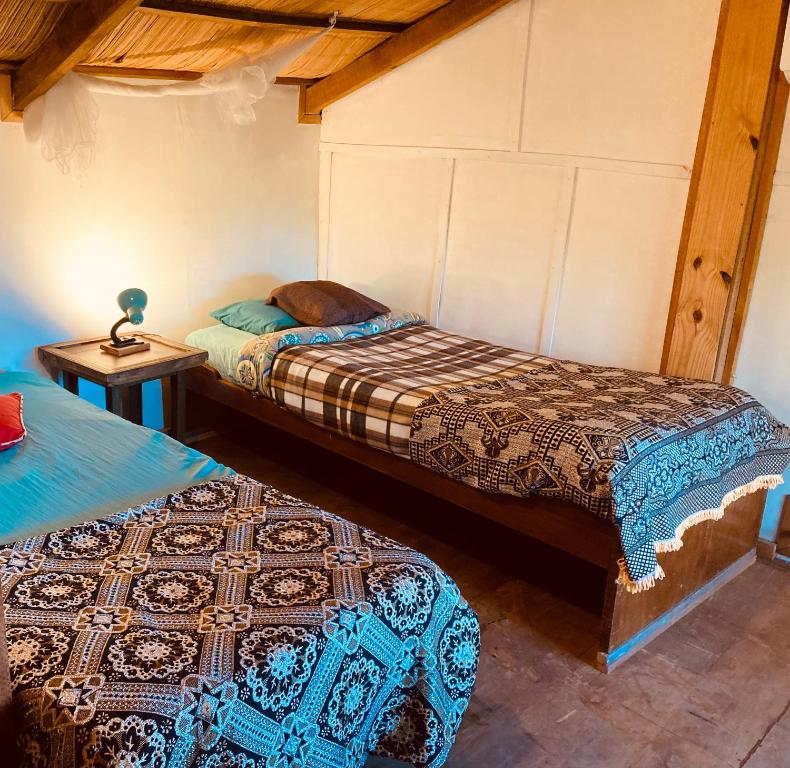 Postel nebo postele na pokoji v ubytování Las Cabañas de Ana
