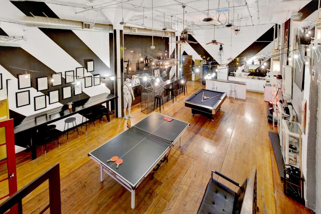 a ping pong room with two ping pong tables at St. Vincent Lofts in Los Angeles