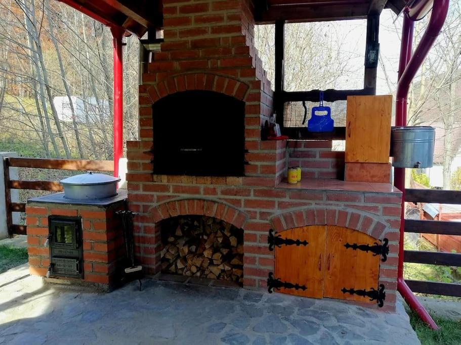 an outdoor brick oven with a stove at Old Mark's House Sinaia in Sinaia