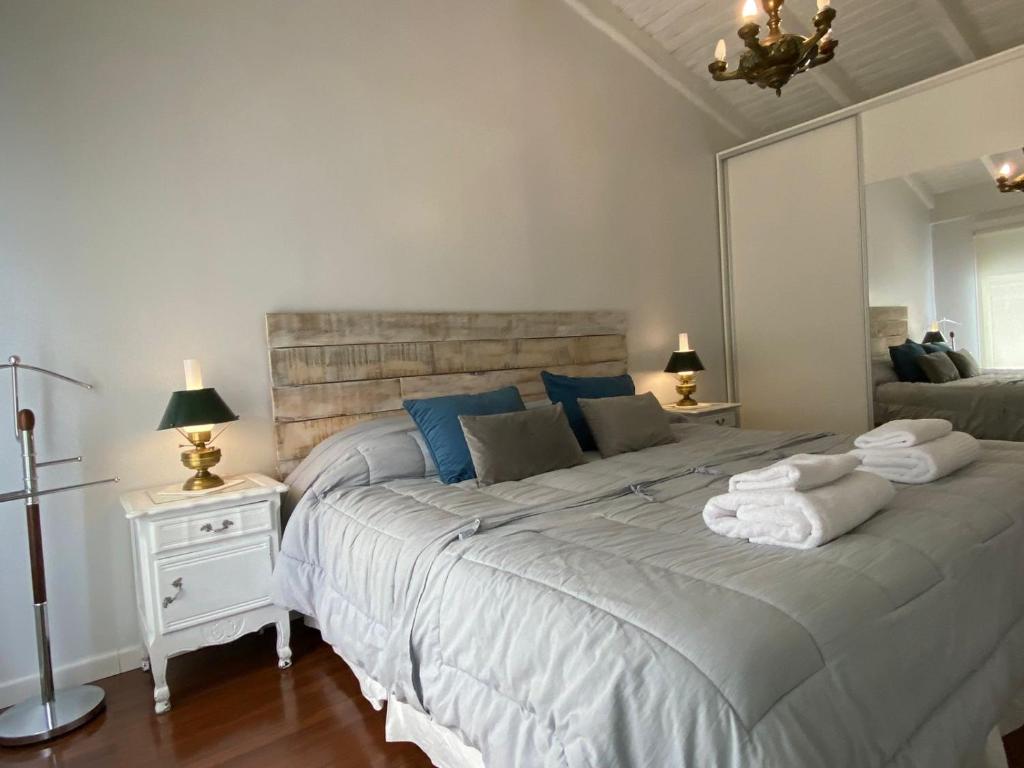 a bedroom with a large bed with towels on it at Casa Le Martial in Ushuaia