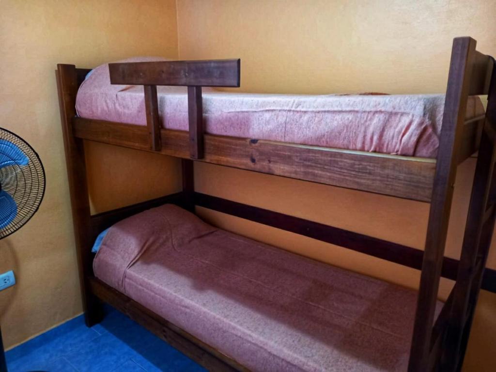 two bunk beds in a room with a small bed at Pucará in Federación