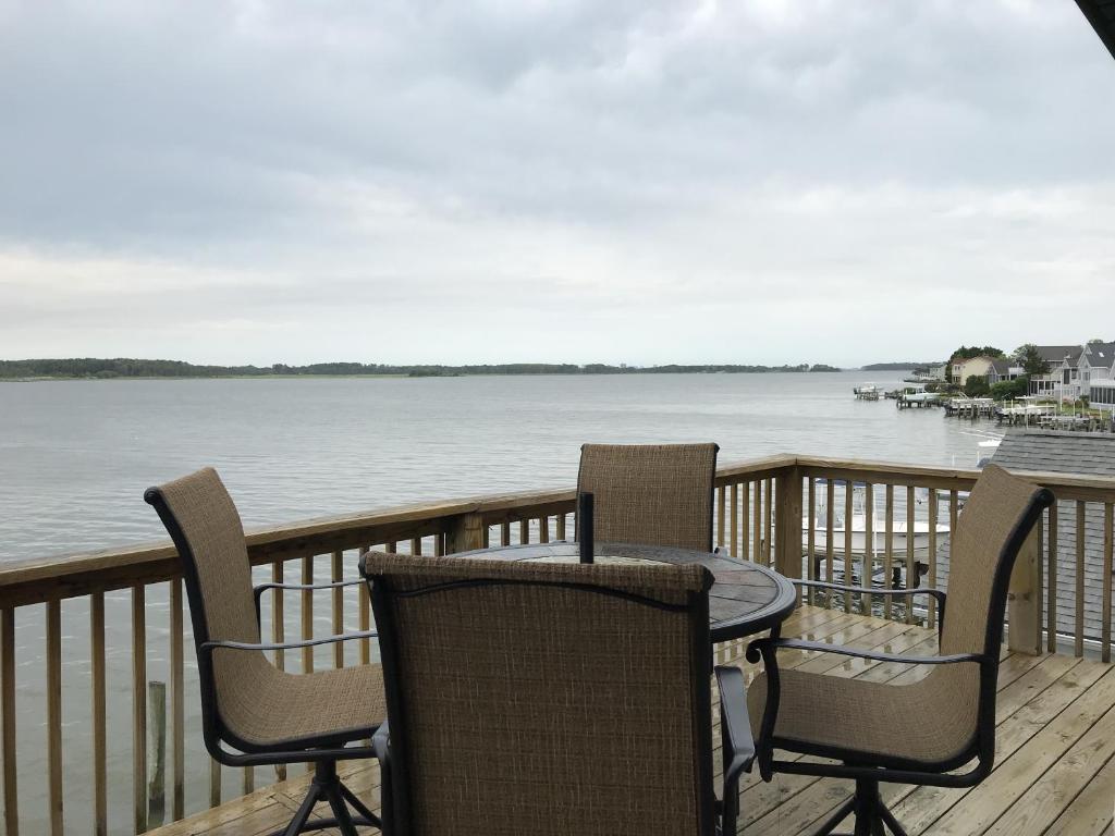 a table and chairs on a deck overlooking the water at 14 Clipper on the Bay in Ocean Pines
