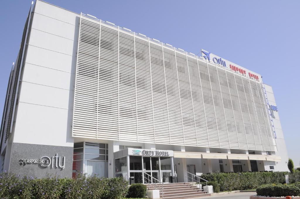 a large building with a sign on the side of it at Orty Airport Hotel in Izmir