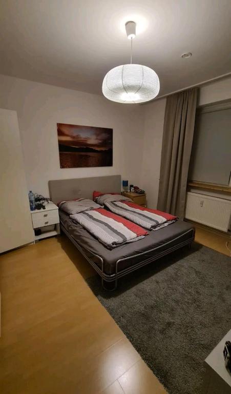 Hotel Apartment im Zentrum, a bedroom with a large bed with a light at Apartment im Zentrum in Frankfurt
