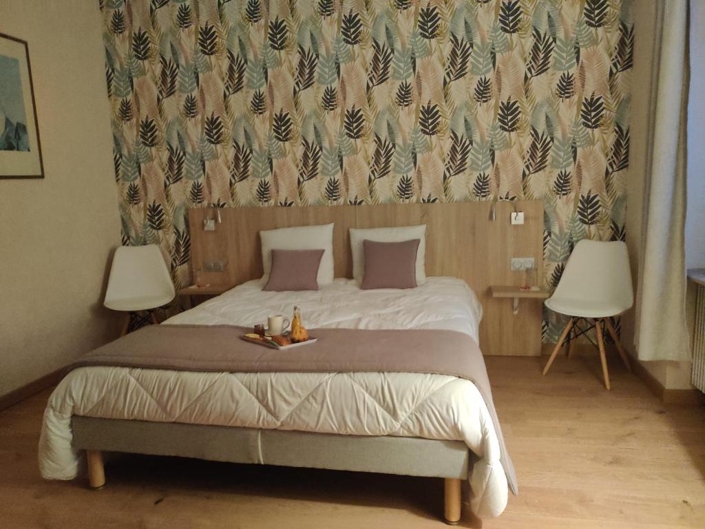 a bedroom with a large bed with two lamps at cocon des lys in Saint-Louis