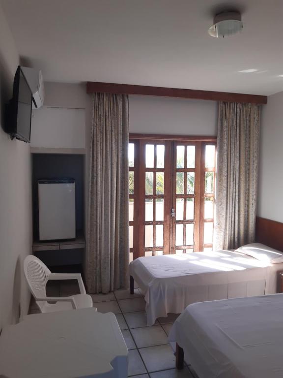 Postel nebo postele na pokoji v ubytování Quiriri Park Hotel