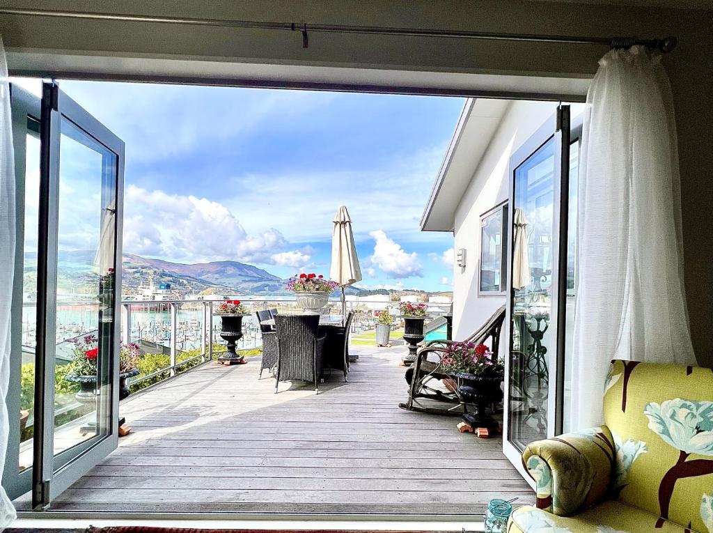a large balcony with a view of a city at Sea views in luxury at LYTTELTON BOATIQUE HOUSE - 14 km from Christchurch in  Lyttelton