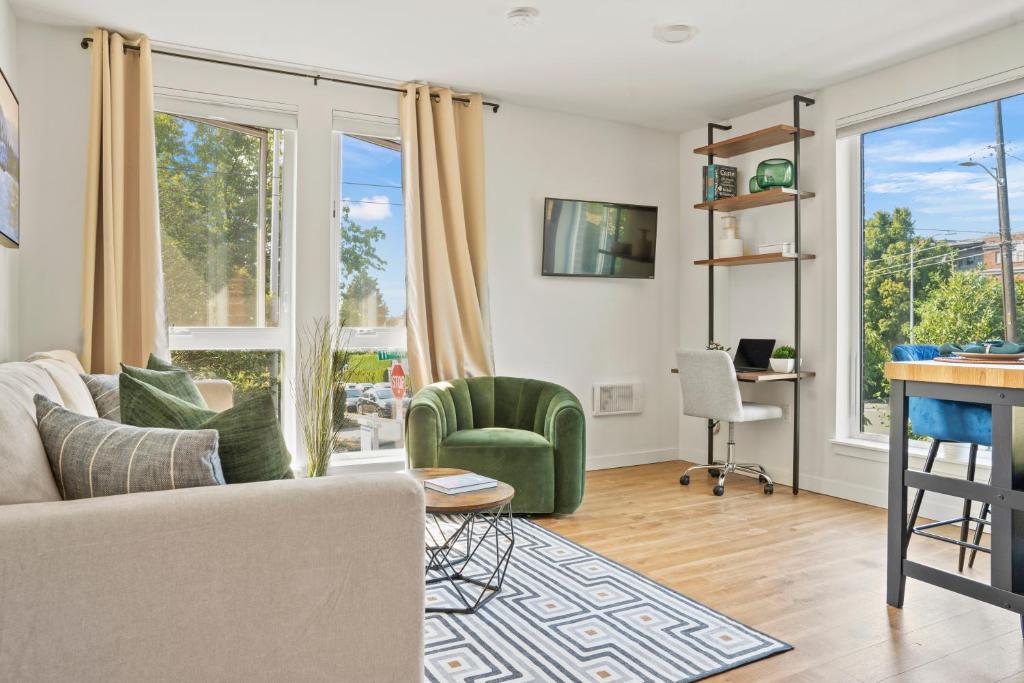 a living room with a couch and a chair at NEW Bright Capitol Hill Condo, Great Location Views in Seattle