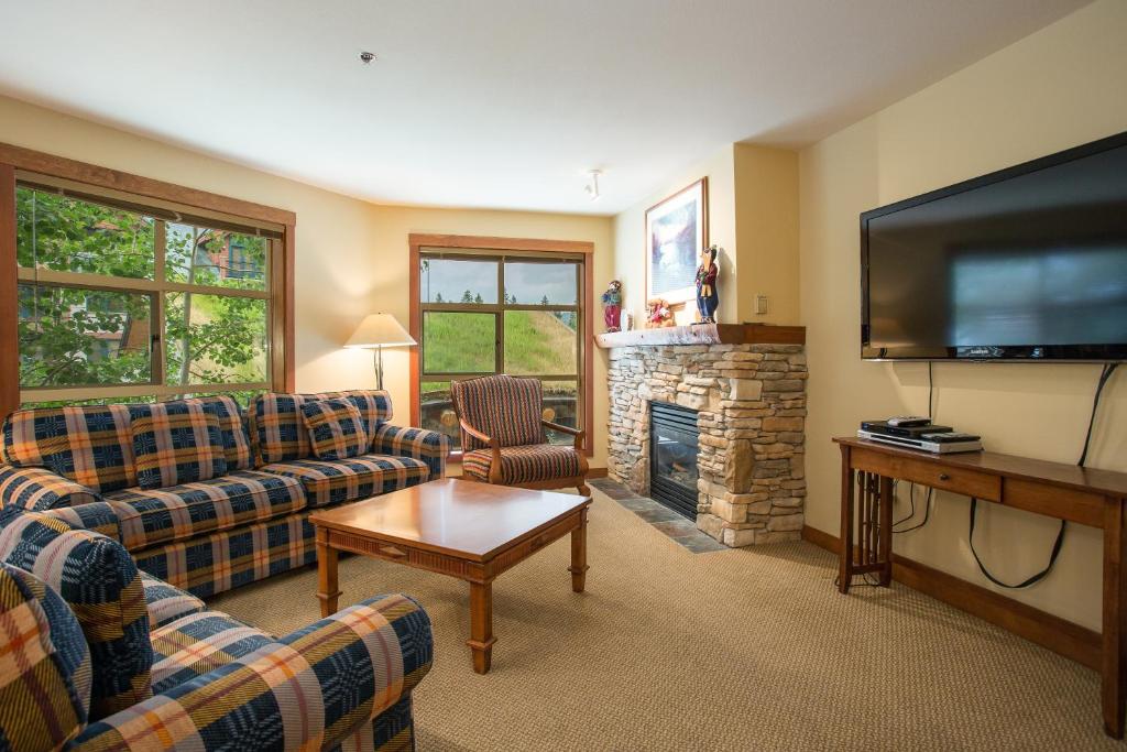 a living room with couches and a flat screen tv at 3219 - Three Bedroom Standard Powderhorn Lodge condo in Solitude