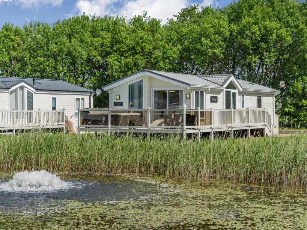 a modular home on the shore of a body of water at Links Lodge in Grange Over Sands