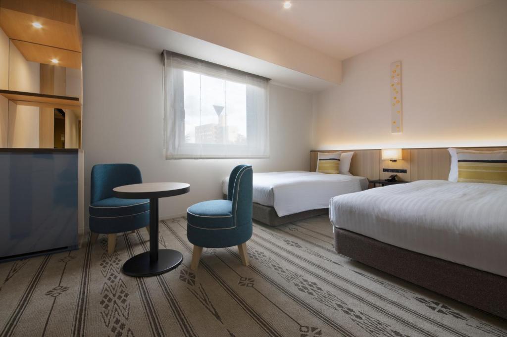 Postel nebo postele na pokoji v ubytování Hotel Vista Fukuoka Nakasu-Kawabata
