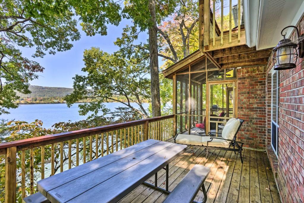 a wooden deck with a wooden table and a bench at Ideal Chickamauga Lake Home and Dock and Fire Pit in Soddy-Daisy