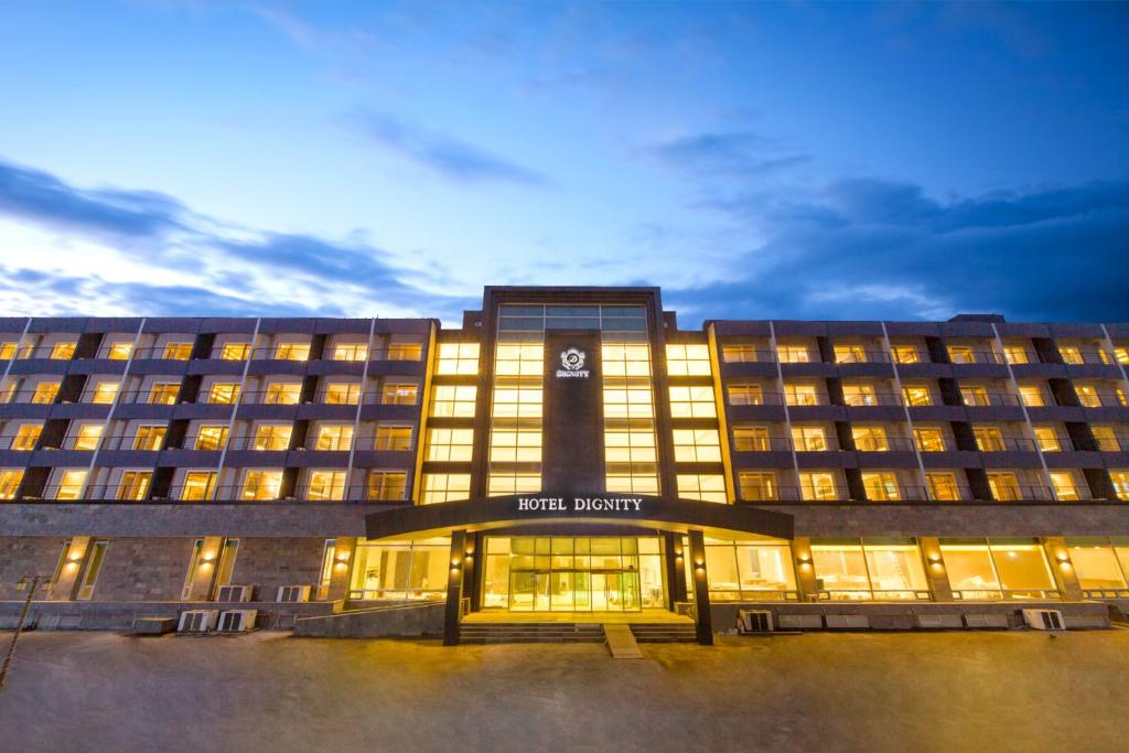 a hotel building with its lights on at night at Dignity Hotel in Yangyang