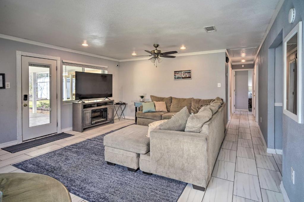 a living room with a couch and a tv at Family-Friendly Baton Rouge Abode with Patio! in Baton Rouge