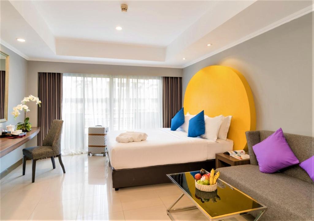 a bedroom with a bed and a living room at FuramaXclusive Sukhumvit in Bangkok