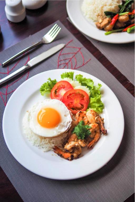 a plate of food with an egg and rice at FuramaXclusive Sukhumvit in Bangkok