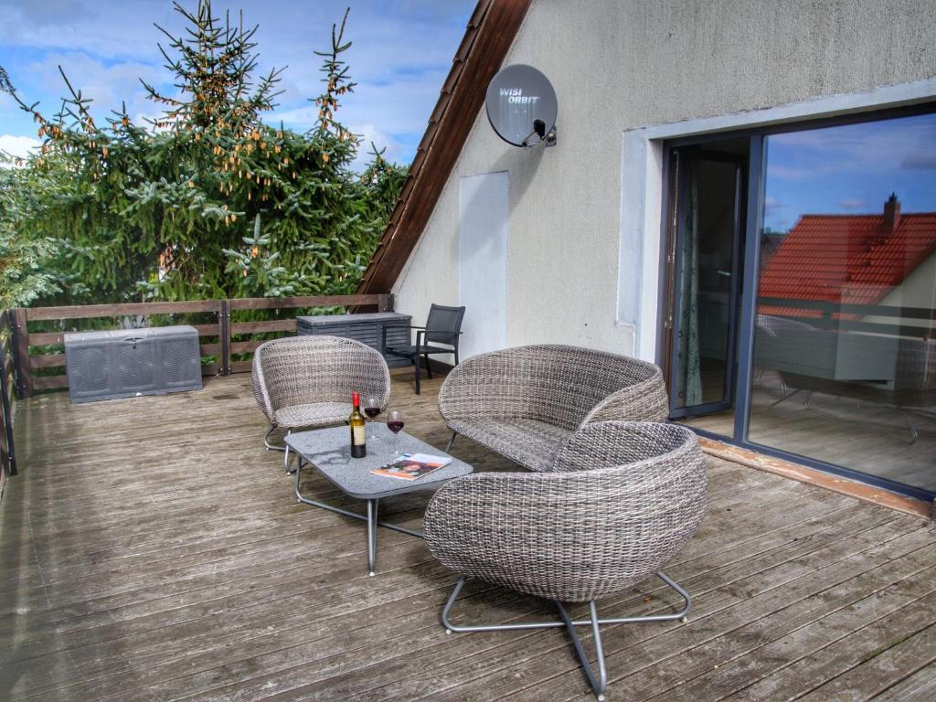 a group of chairs and a table on a deck at Mönkebude Coastal Garden Stay in Mönkebude