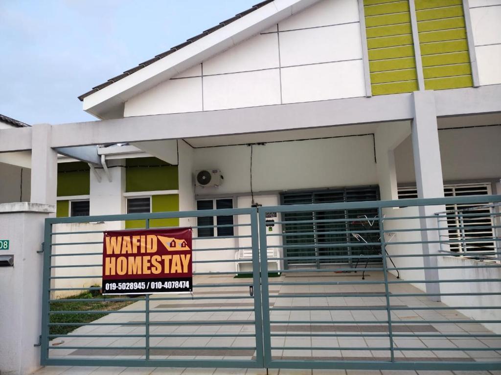 a sign in front of a building at WAFID HOMESTAY SERI ISKANDAR in Seri Iskandar