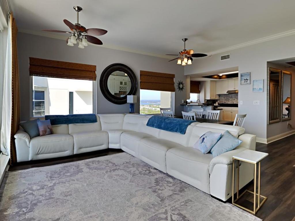 a living room with a white couch and a kitchen at Indigo West #2004 in Perdido Key