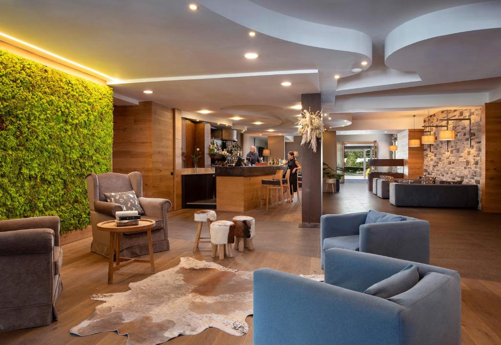 a lobby with blue chairs and a living room at Sport Village Hotel & Spa in Castel di Sangro