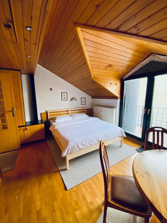 a large bedroom with a bed and a table at Apartma Snežinka in Kranjska Gora