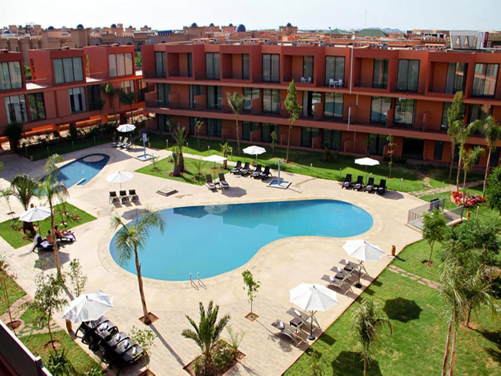 an aerial view of a hotel with a swimming pool at Rawabi Hotel Marrakech & Spa in Marrakech