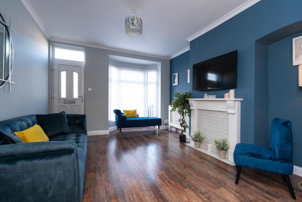 a blue living room with a couch and a fireplace at belmont street in Hull