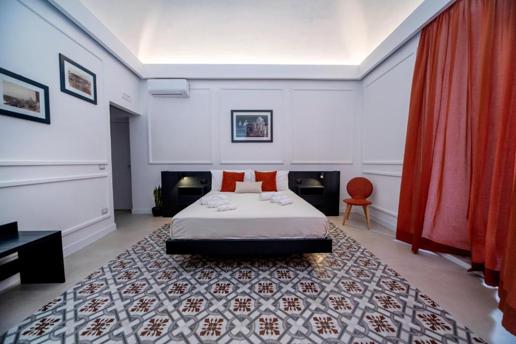 a bedroom with a bed and a red curtain at B&B Riccioli in Catania
