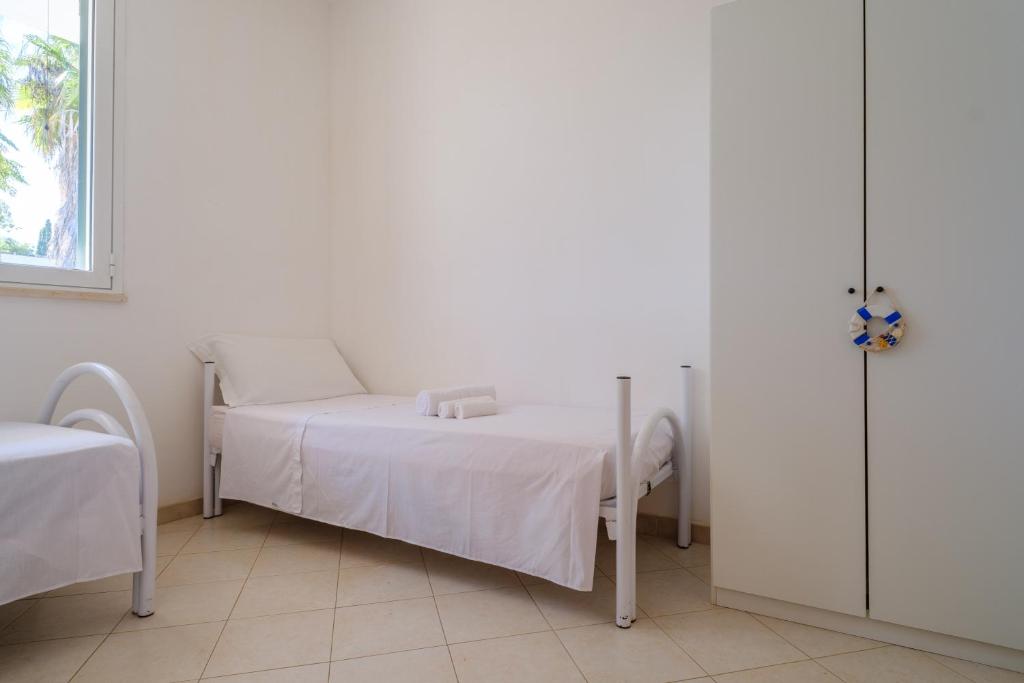 Posteľ alebo postele v izbe v ubytovaní Villetta Libeccio Torre dell'orso