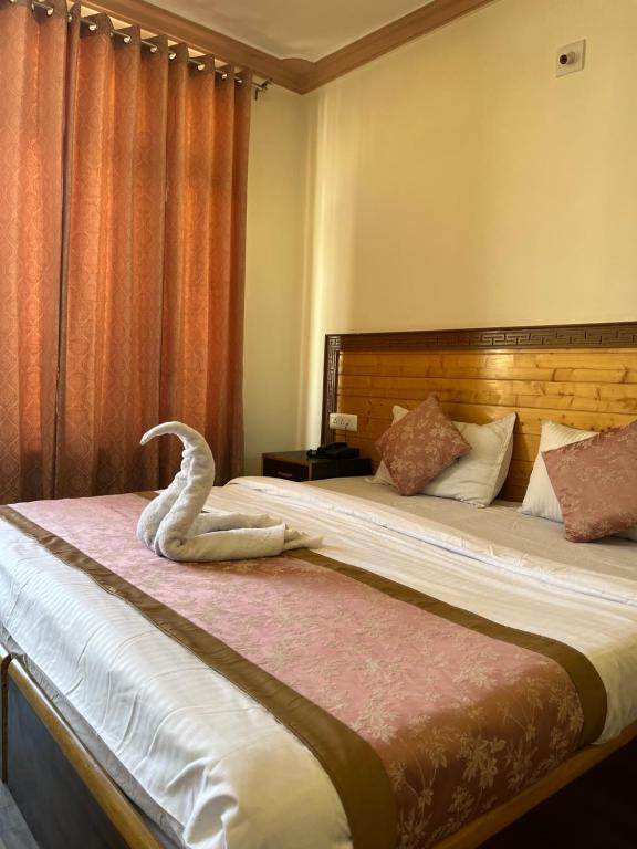 a hotel room with two beds with a snake on it at zikzik holidays in Leh