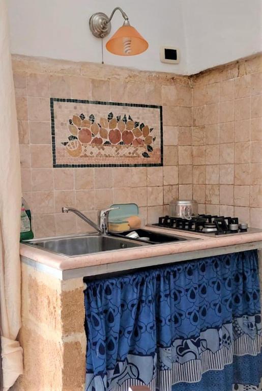 a kitchen with a sink and a stove at Bed & Breakfast Porta d'Oriente in Brindisi