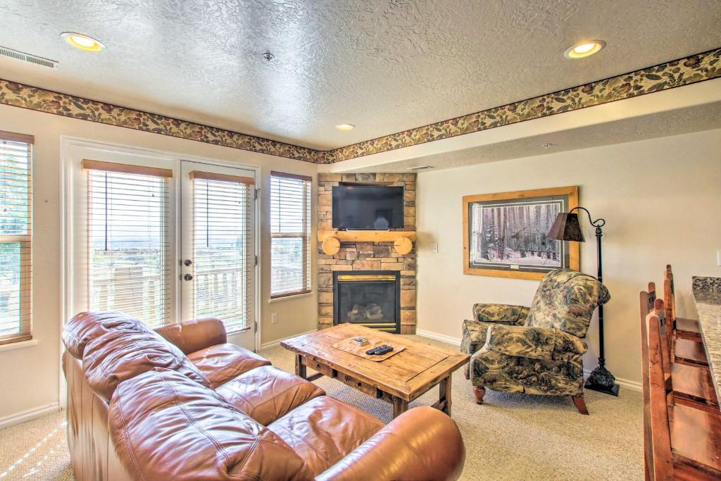 a living room with a couch and a table and a fireplace at Cozy Eden Condo Retreat Less Than 6 Mi to Ski Resort! in Eden