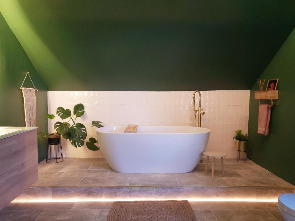 a large bath tub in a bathroom with a green ceiling at Luxury 4 Bed Family property in popular location in Sheffield